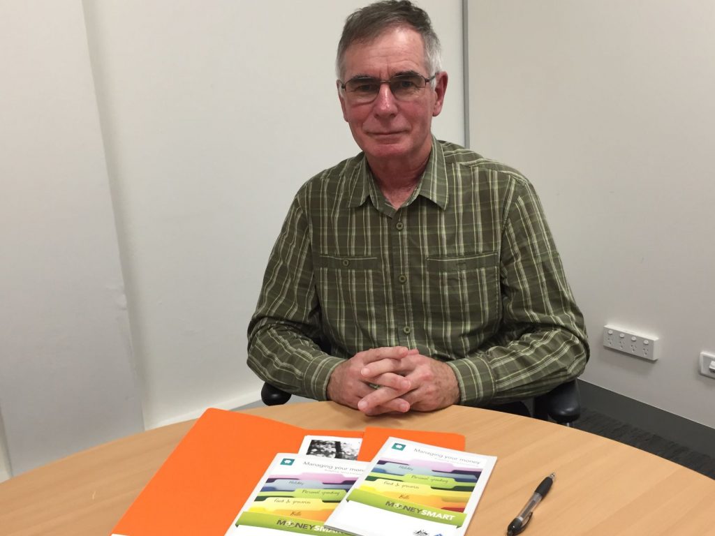 Financial counsellor sitting at table.