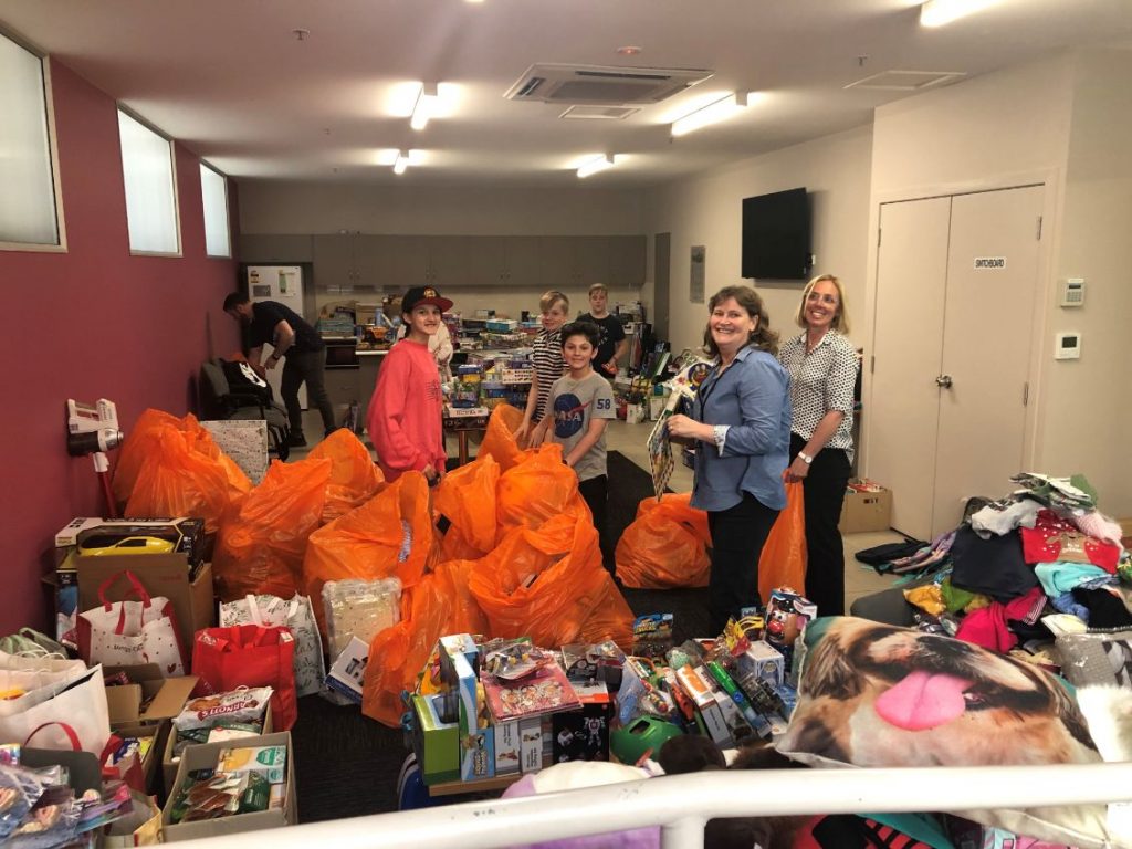 Margaret Savage and volunteers sorting through gift donations for the Anglicare Christmas Appeal 2019.