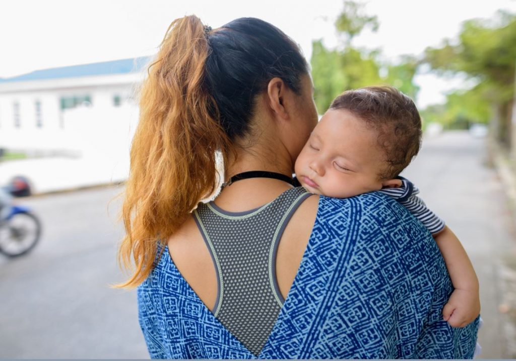 Picture of a mother with her baby asleep on her shoulder. Anglicare can help to protect you from domestic and family violence.