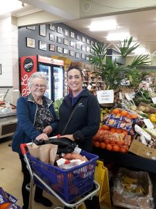 Support worker takes client grocery shopping