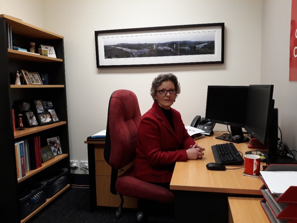 Financial Counsellor sitting at her desk in her office.