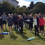 A photo of Margaret receiving a donation from the Fitness in the Park group