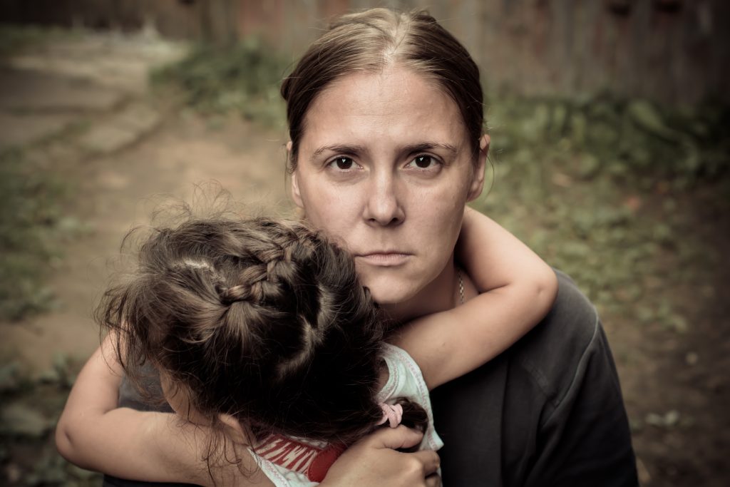 Conversation on use of word Vulnerable. Led by TasCOSS and featuring key speaker Dr Catherine Robinson from Anglicare Tasmania. Picture of a homeless mother hugging child looking worried.