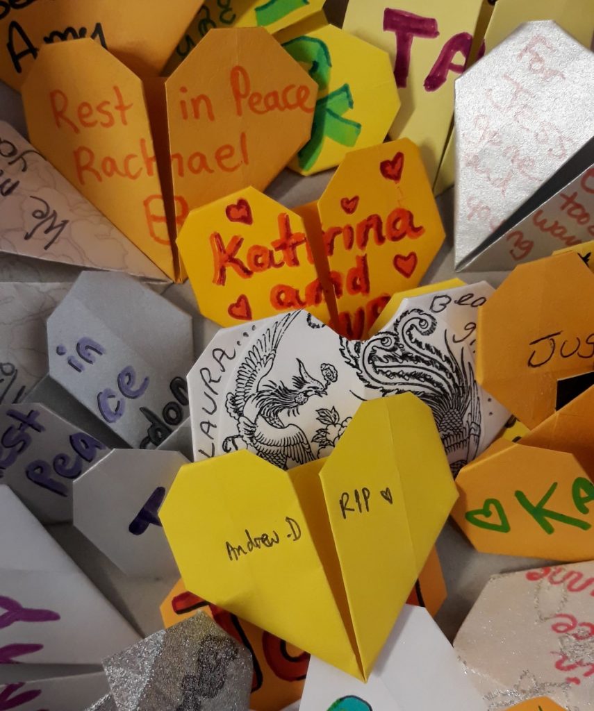 paper hearts with messages to lost ones as a result of overdose