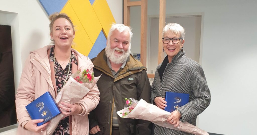 North West Tasmania Housing Connect Team members receiving a gift of chocolates and flowers from a client they helped.