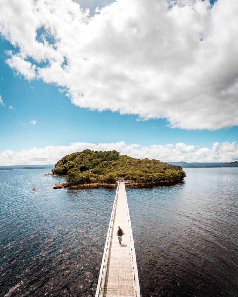 Person walking the jetty onto the Port Arthur Historic Site Isle of the Dead in Tasmania.