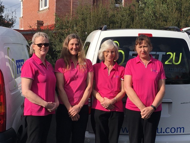 Photo of the team from Feet2U in their pink shirts