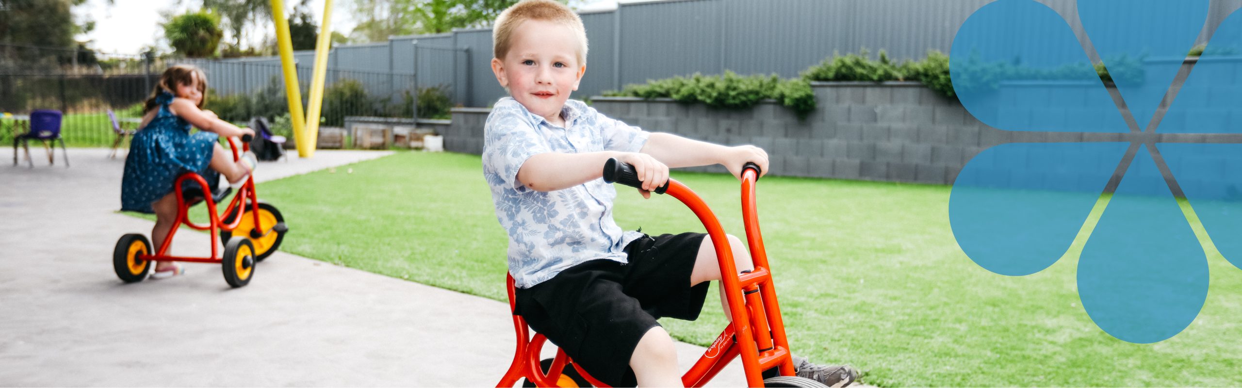 young child riding a red bike