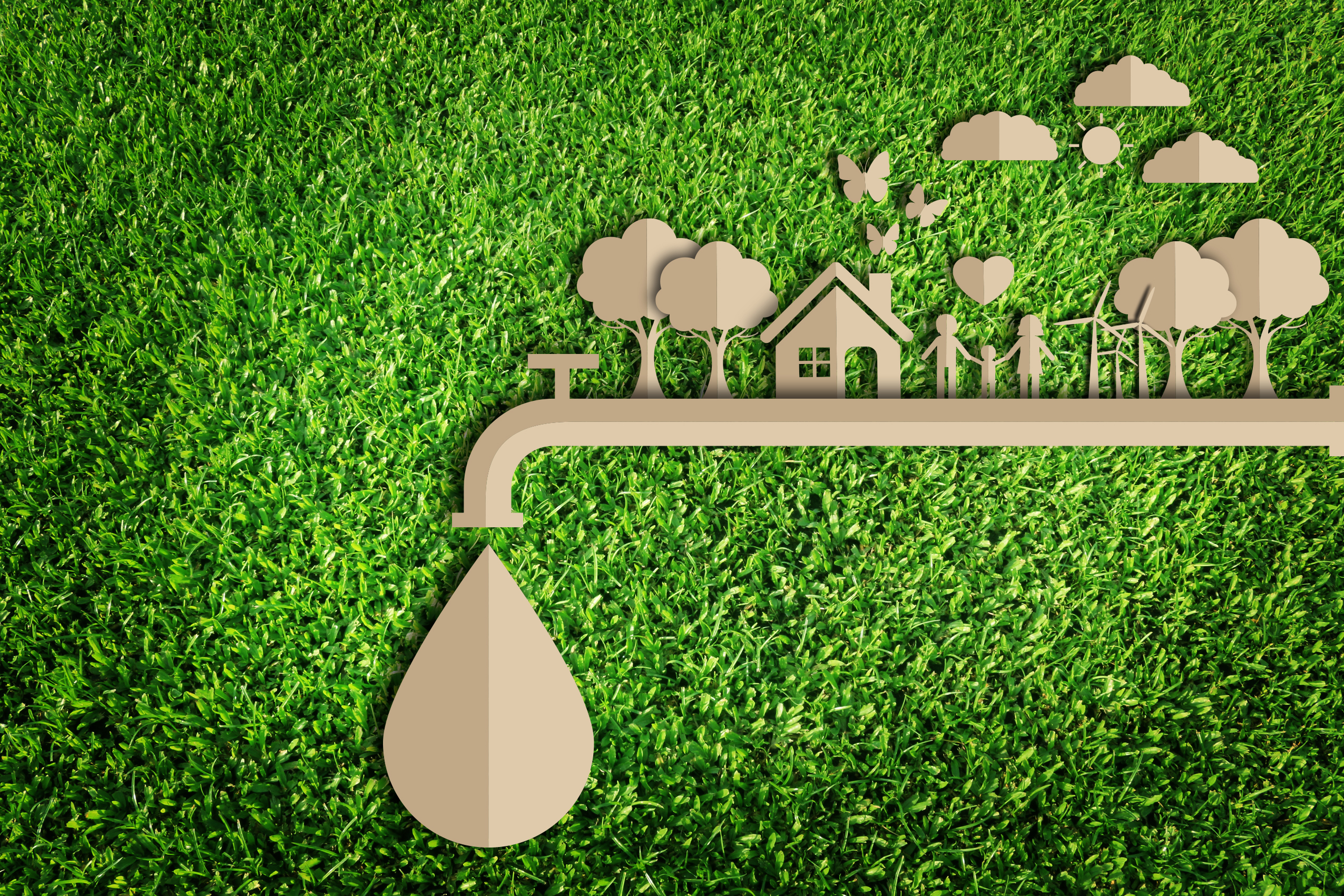A cardboard cut-out of a family holding hands outside their home surrounded by trees and butterflies while everything is built upon a water pipe with a singular drop of water falling from the pipe.