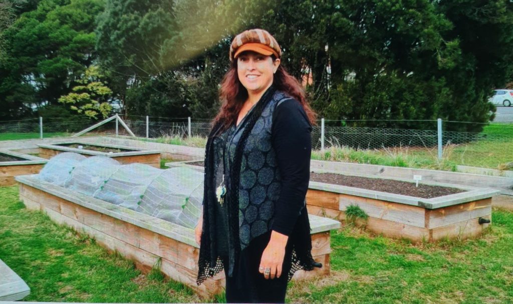 Anne- Maree standing in front of the garden beds