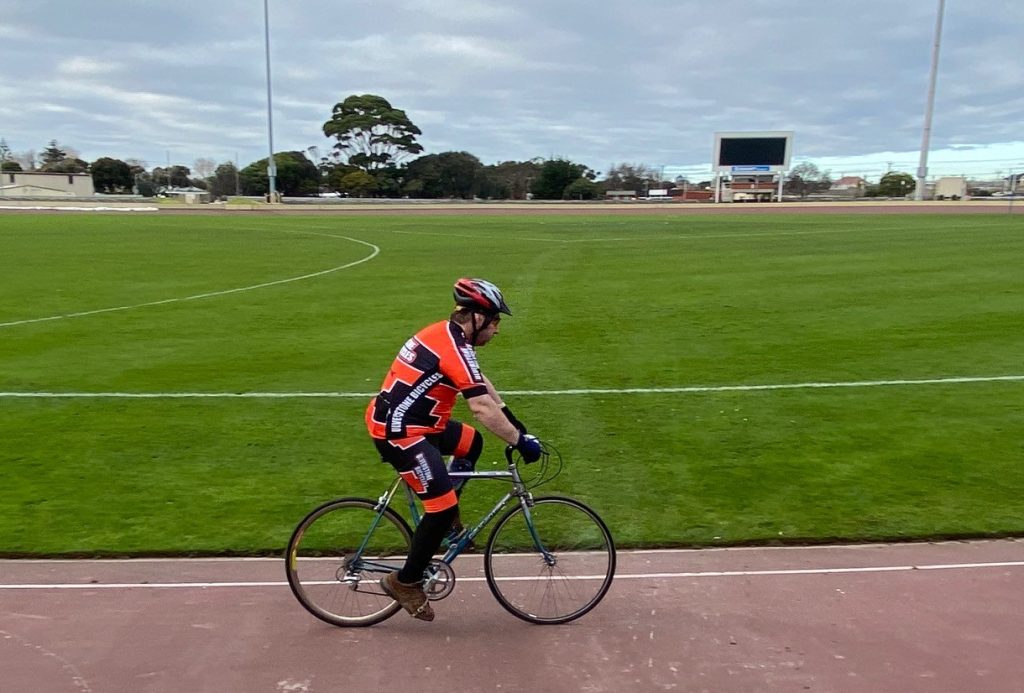 Photo of mathew riding his bike on a cycling track