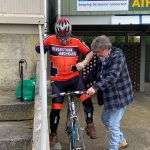 Graham is helping mathew to get onto his bike