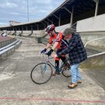 Graham is helping Mathew to keep the bike steady has he takes off