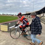 Graham is helping Mathew to keep steady as he takes off on his bike