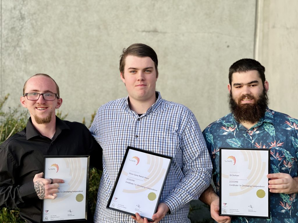 A photo of 3 boys holding their new TAFE certificates