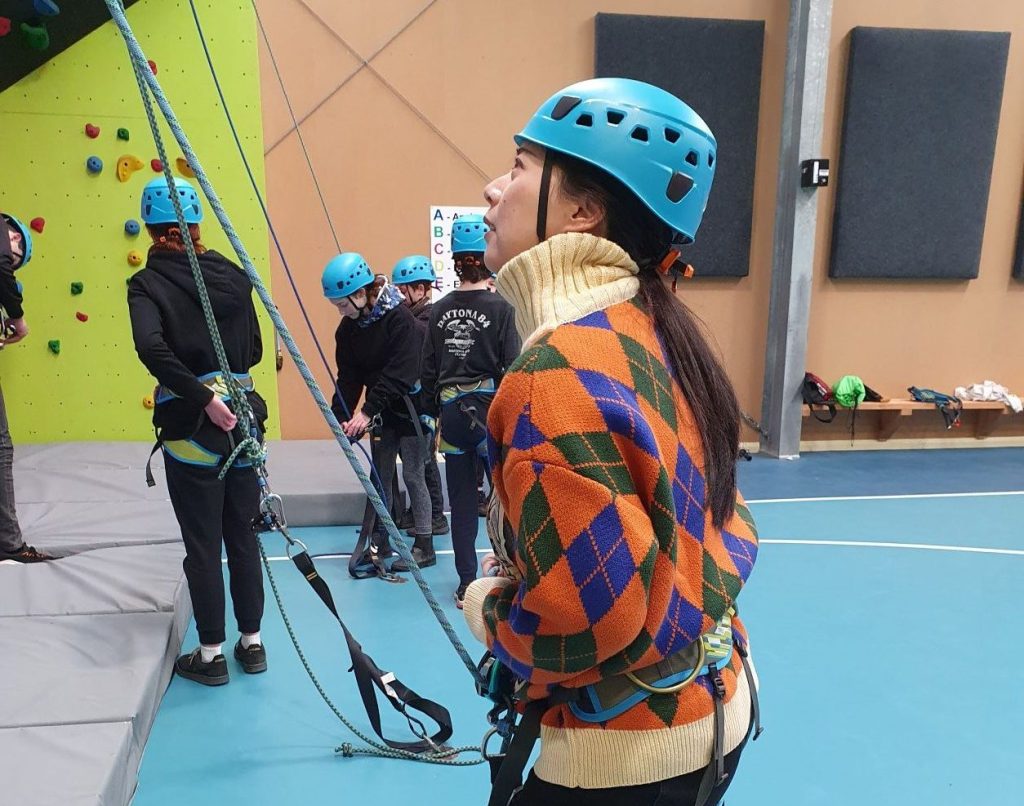 University of Tasmania Social Work student Natalie prepares to scale the climbing wall at the Taz Kids camp.