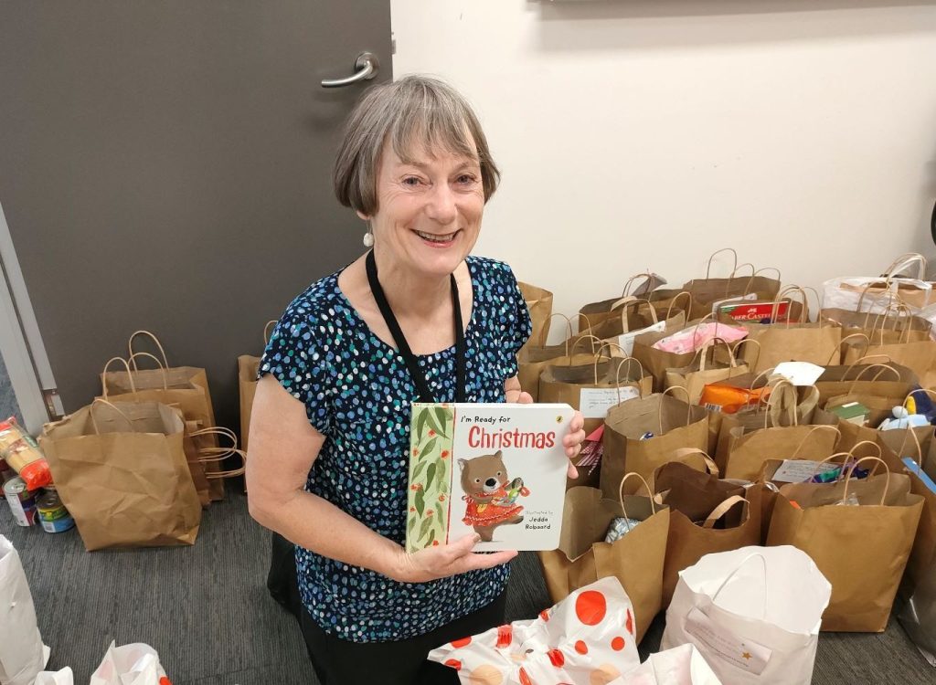 A photo of Katrina holding a childrens christmas book