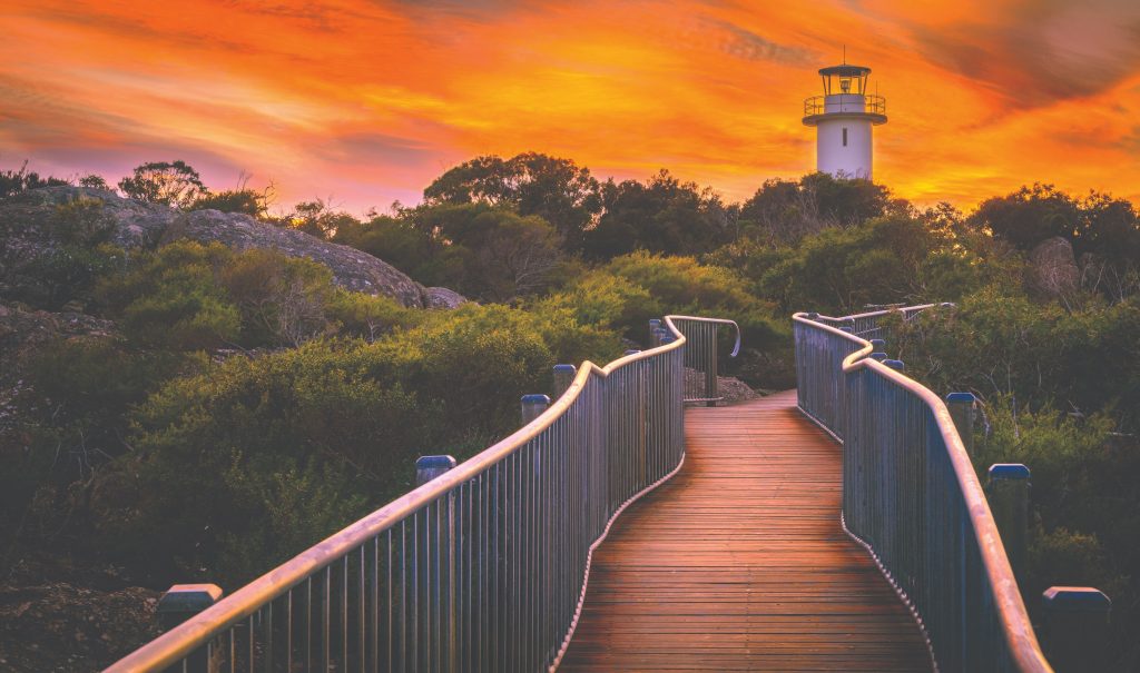 Lighthouse with a stunning sunset in the background.