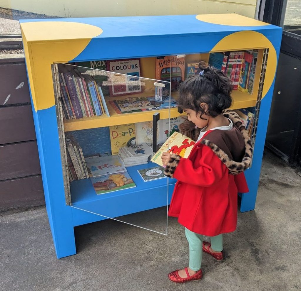 Photo of a child looking at the new street library.