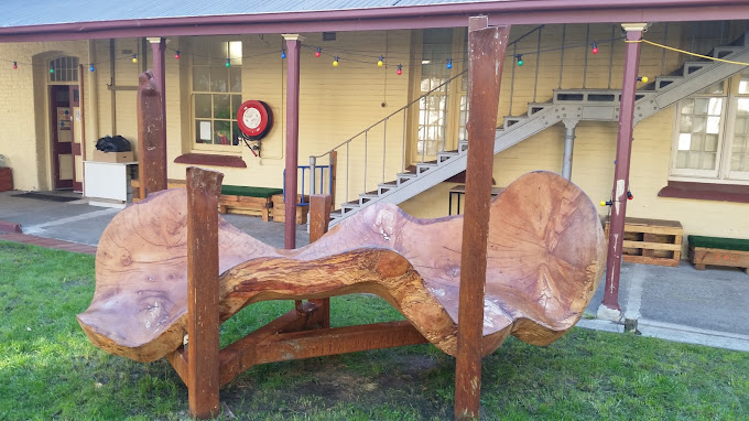 a beautiful large timber artwork that looks like a wave of wood