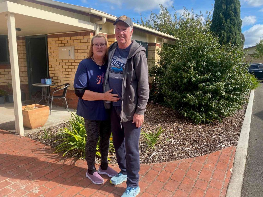 Kevin Purton and his wife standing together and smiling.