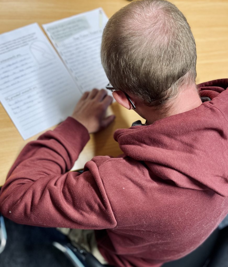 A photo of someone taking a test taken from behind.
