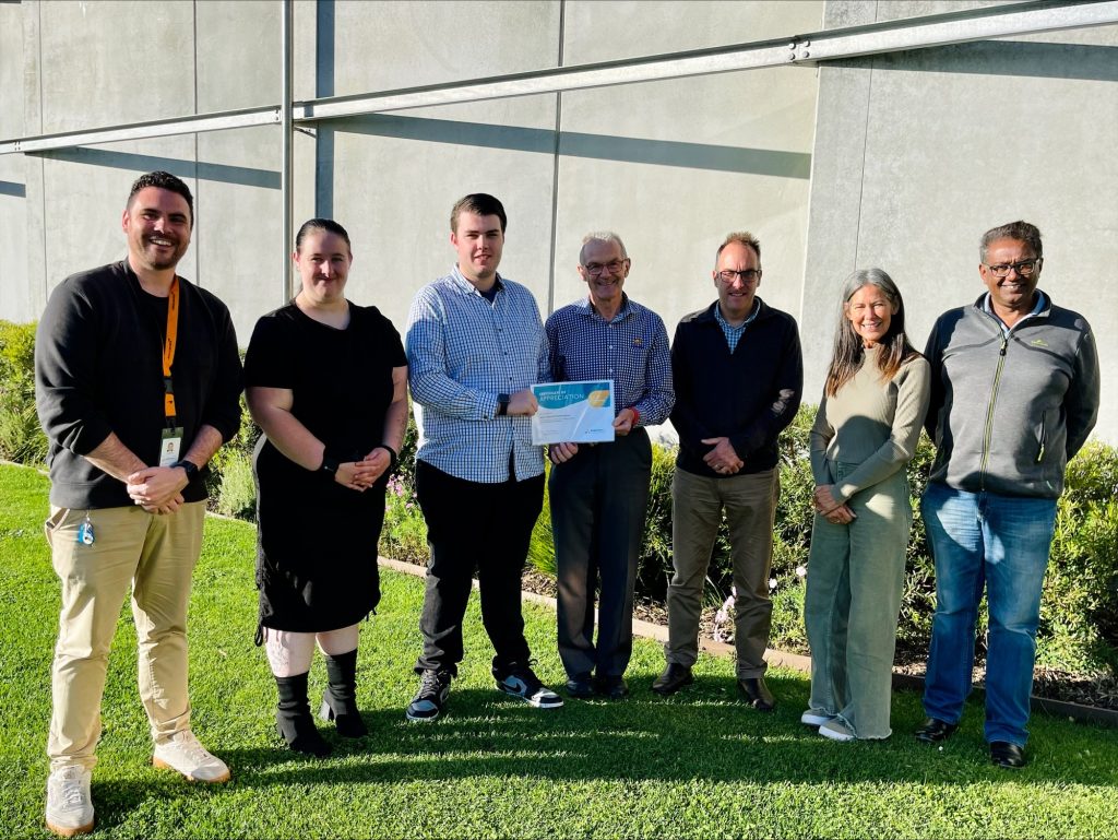 Youth Development Coach Cristian Benton and students Sarah and Shane, AAH hair Royce Fairbrother and board members Andrew Hillier, Cathy McClure and Seeland Nair.