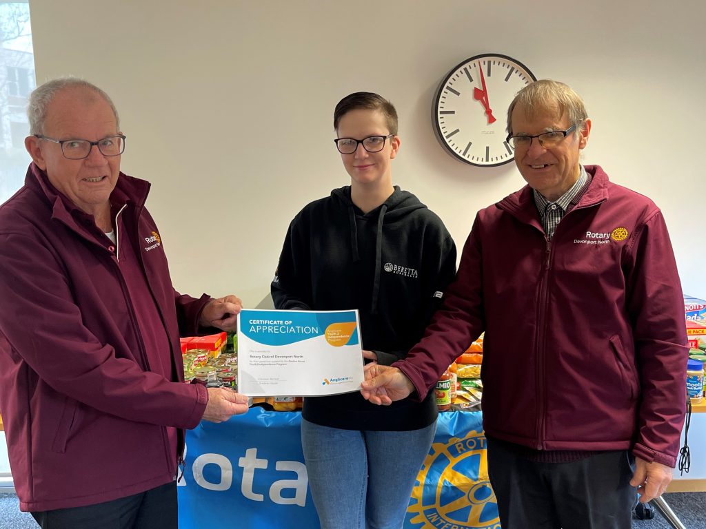 Eveline House student presenting a certificate of appreciation for the donations made by the Rotary Club of Devonport North.