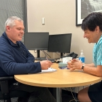 Aaron is Anglicare's Launceston-based Private Market Case Worker. He's pictured here discussing a client's needs with Fran from the Housing Connect service.