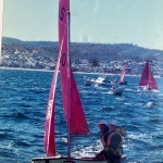 Peter sailing in his boat in a regatta with his grand-daughter