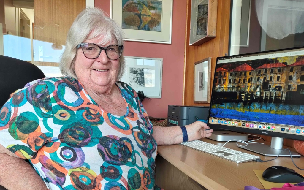 Dianne working on a computer on one of her artworks.