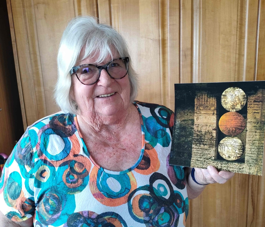 Diane holding her artwork